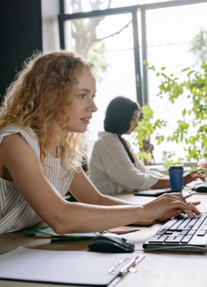 Two women working at their computers in an office