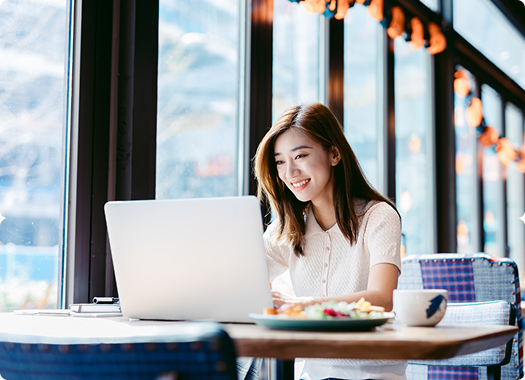 Woman working on her laptop smiling