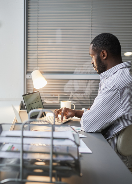 Man working at a laptop in his office 