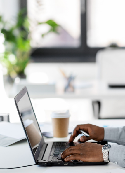 Person working on laptop in a work environment