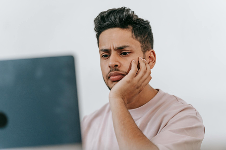 confused man on laptop