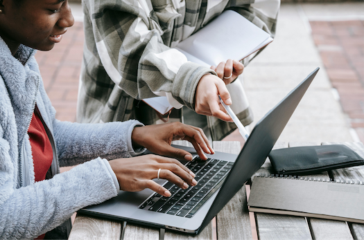 student doing assignment on laptop